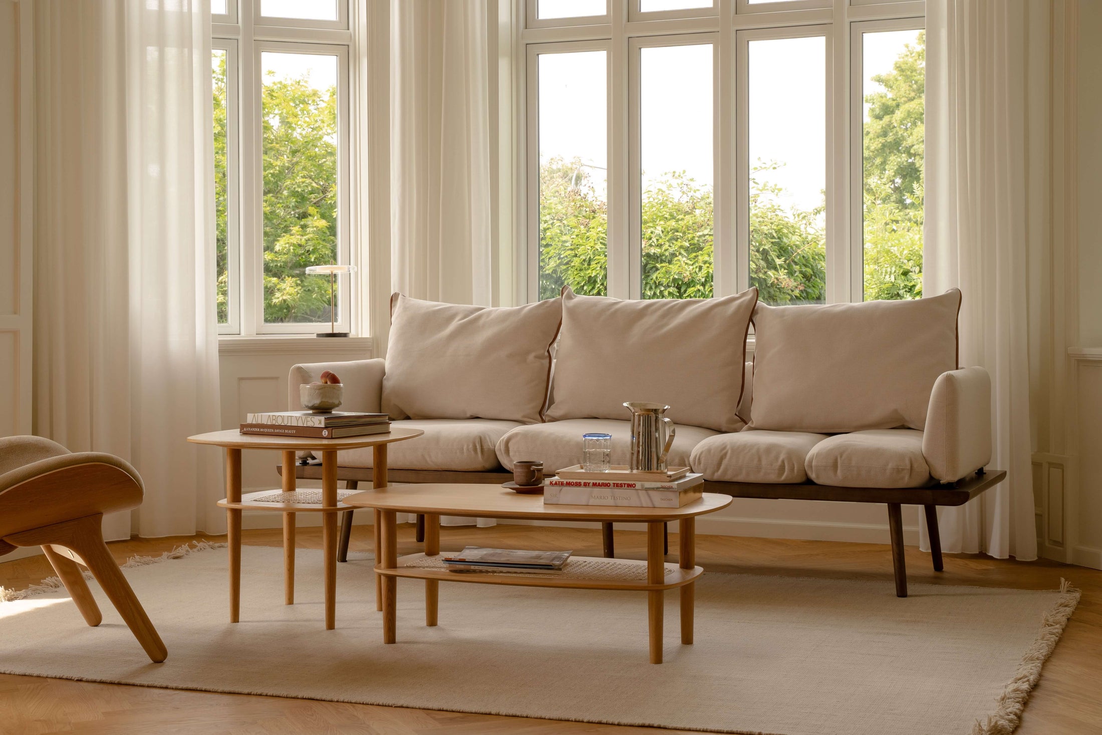 Living room in soft daylight with sofa and table lamp